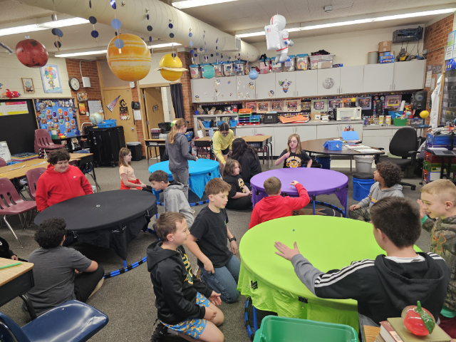 Students doing a hands-on classroom activity with a MESO educator